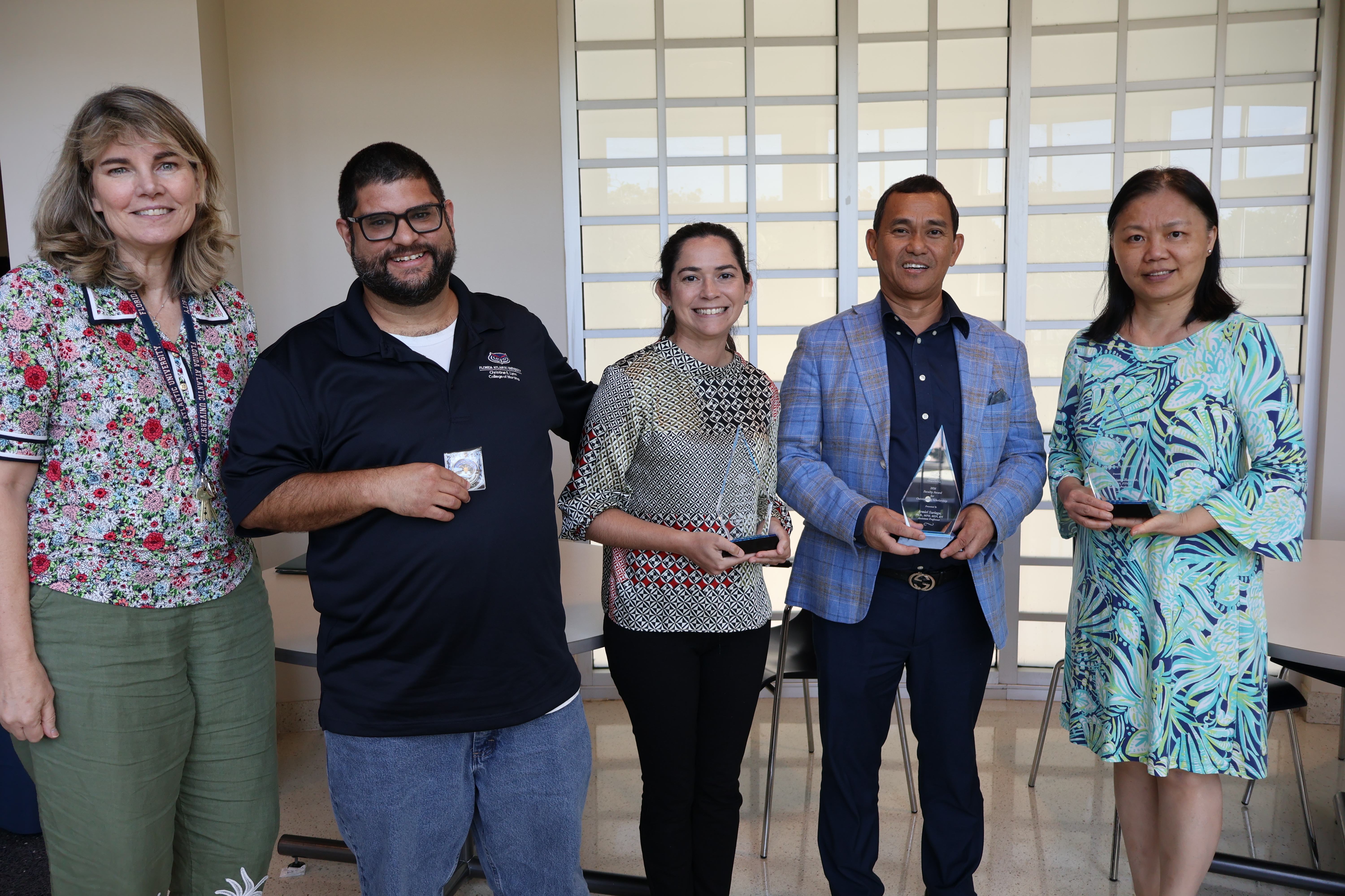 College of Nursing faculty members posing with their research awards