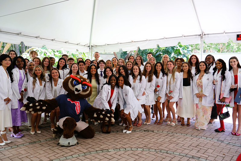 An image of the Spring 2026 graduating FDA BSN students surrounding Owlsy (FAU Mascot)