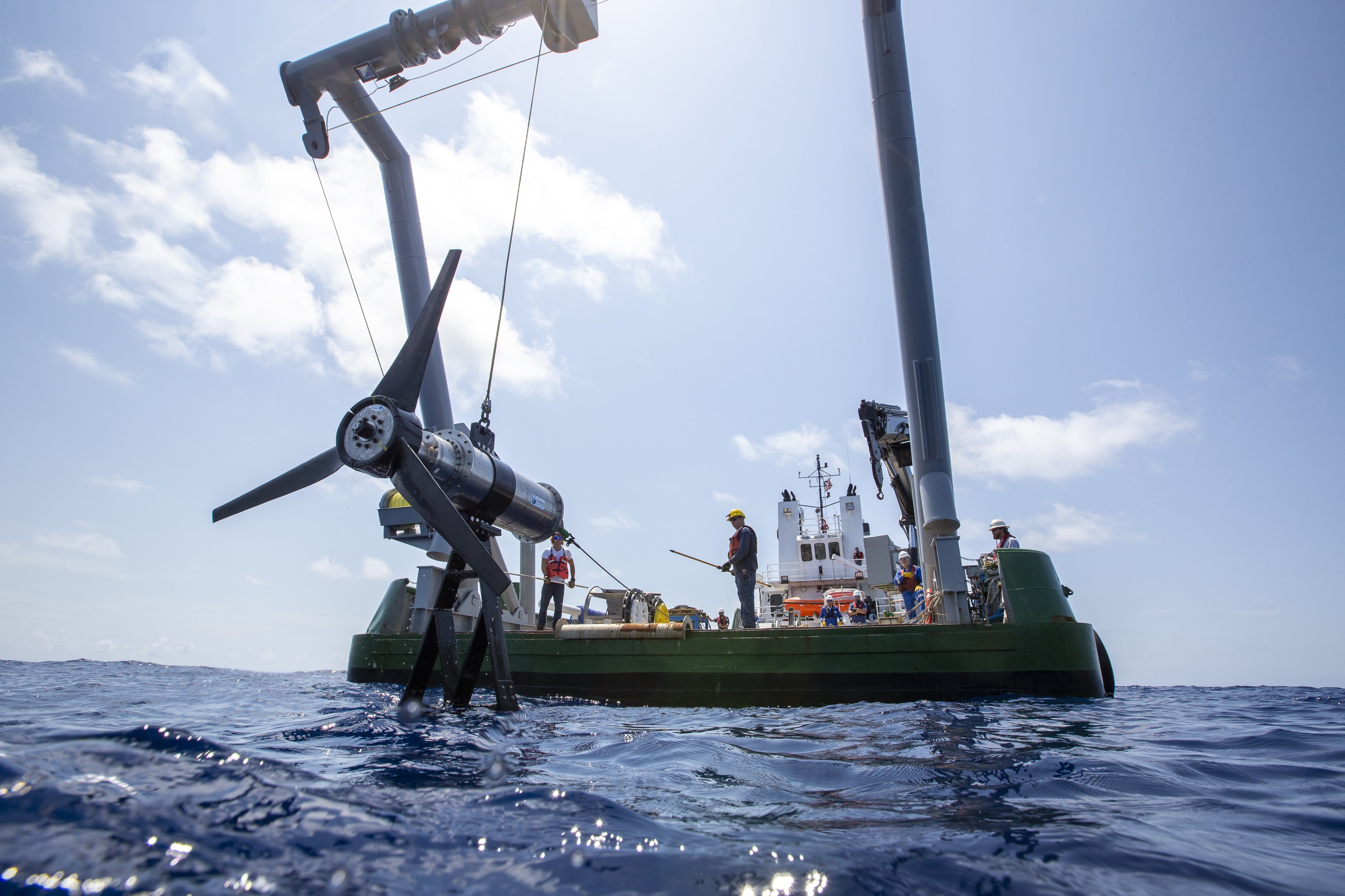 Workers placing turbine in the ocean