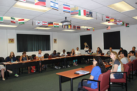 people sitting at tables in a classroom