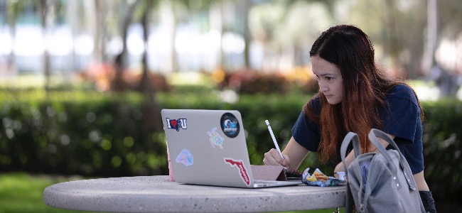 Florida Atlantic University student using laptop