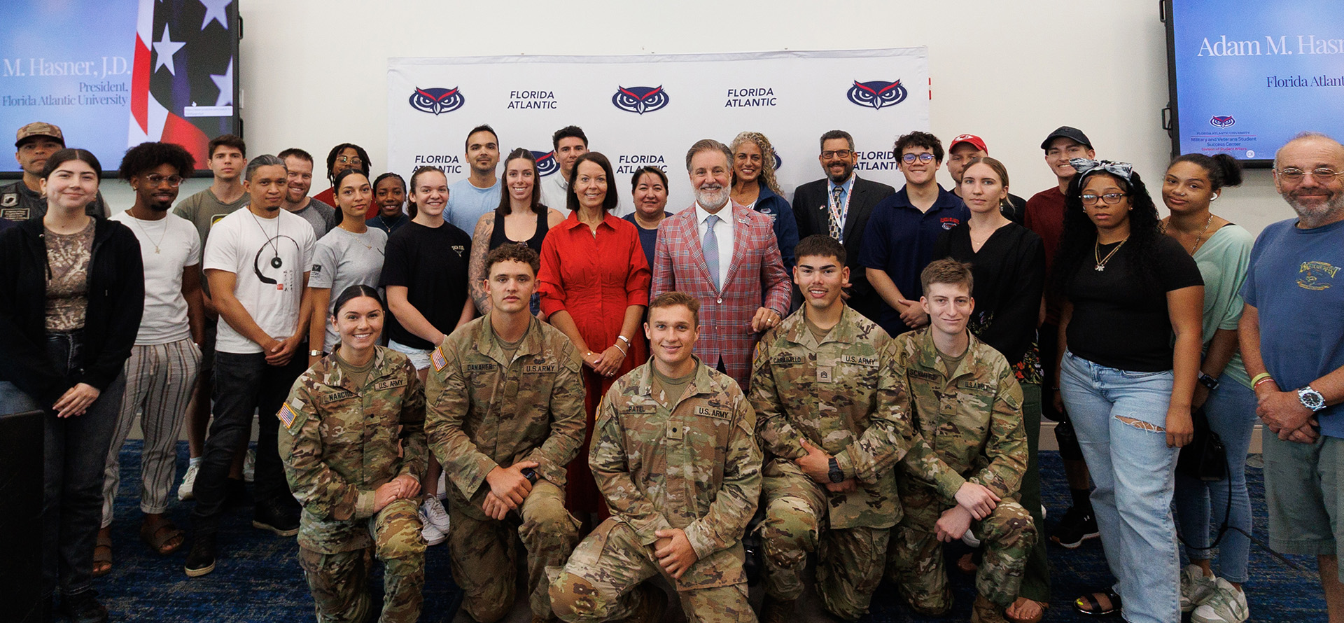President Hasner with and first Lady with a group of people including US Army soldiers.