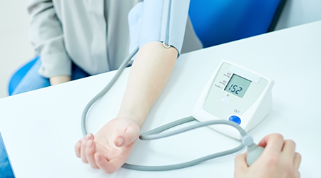 arm with blood pressure cuff on