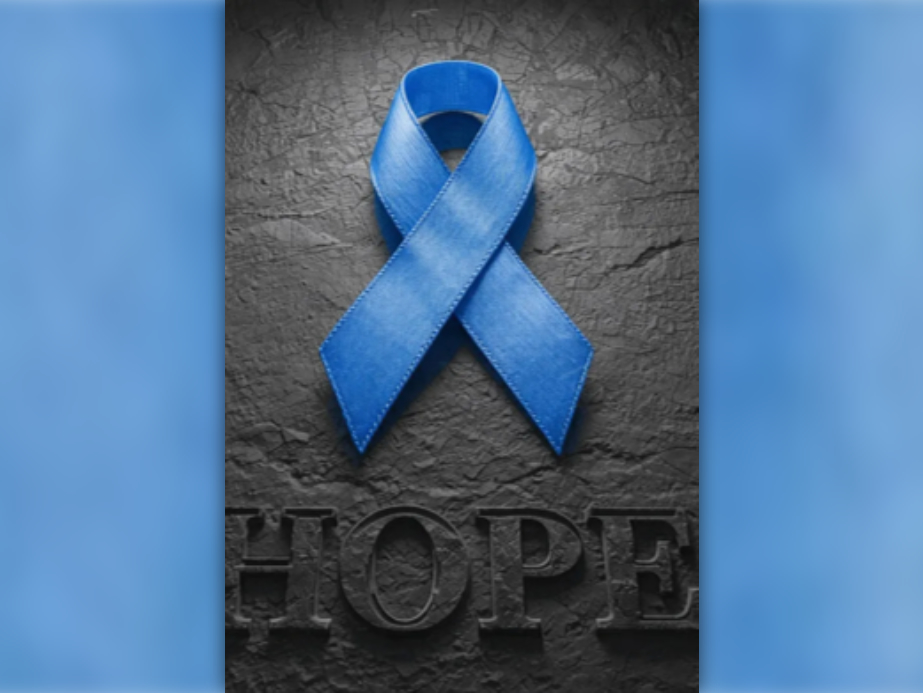bright blue cancer ribbon on dark textured background with word 'Hope' beneath it