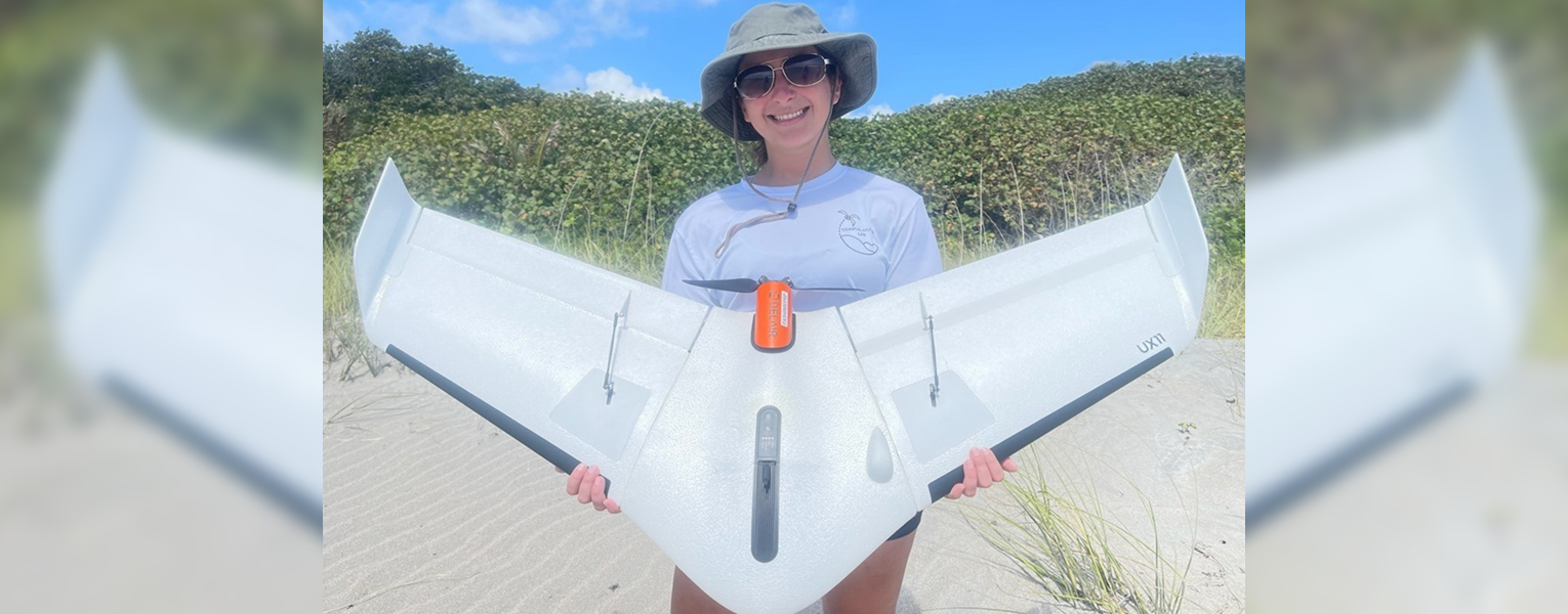 Summer Manestar holding the UX11 unmanned aerial vehicle