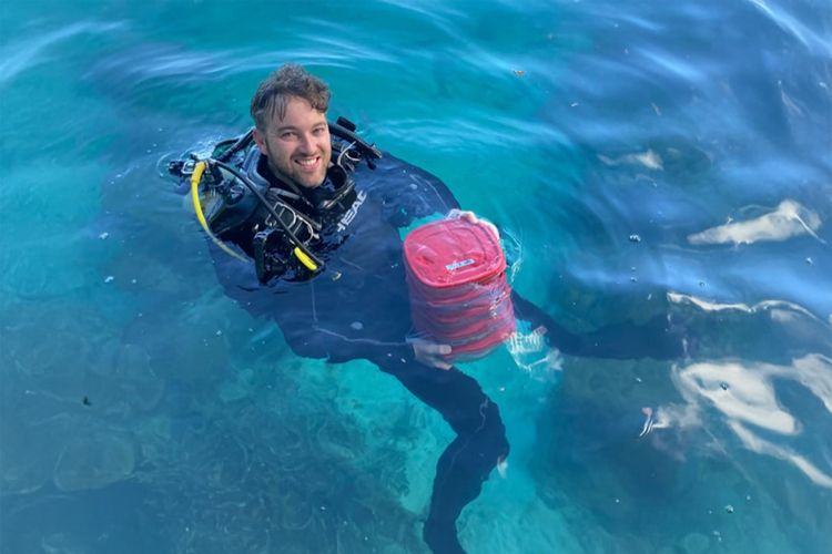 man floating in ocean in scuba gear