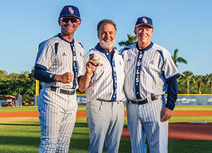 Adam Hasner with two men in baseball uniforms