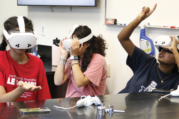 Three children wearing VR headsets