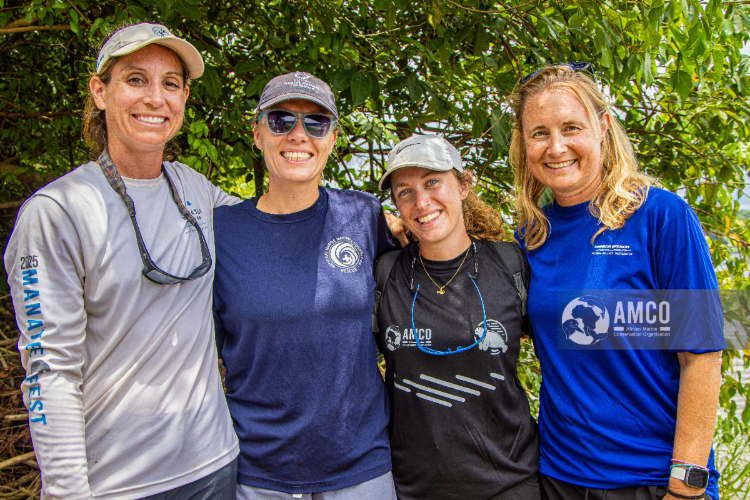 Wendy Marks (right) and other women standing in front of greenery