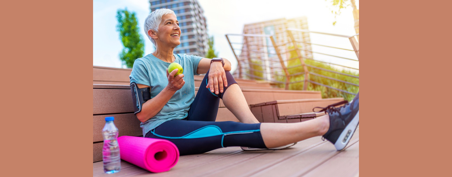 woman sitting on ground, dressed in workout clothes