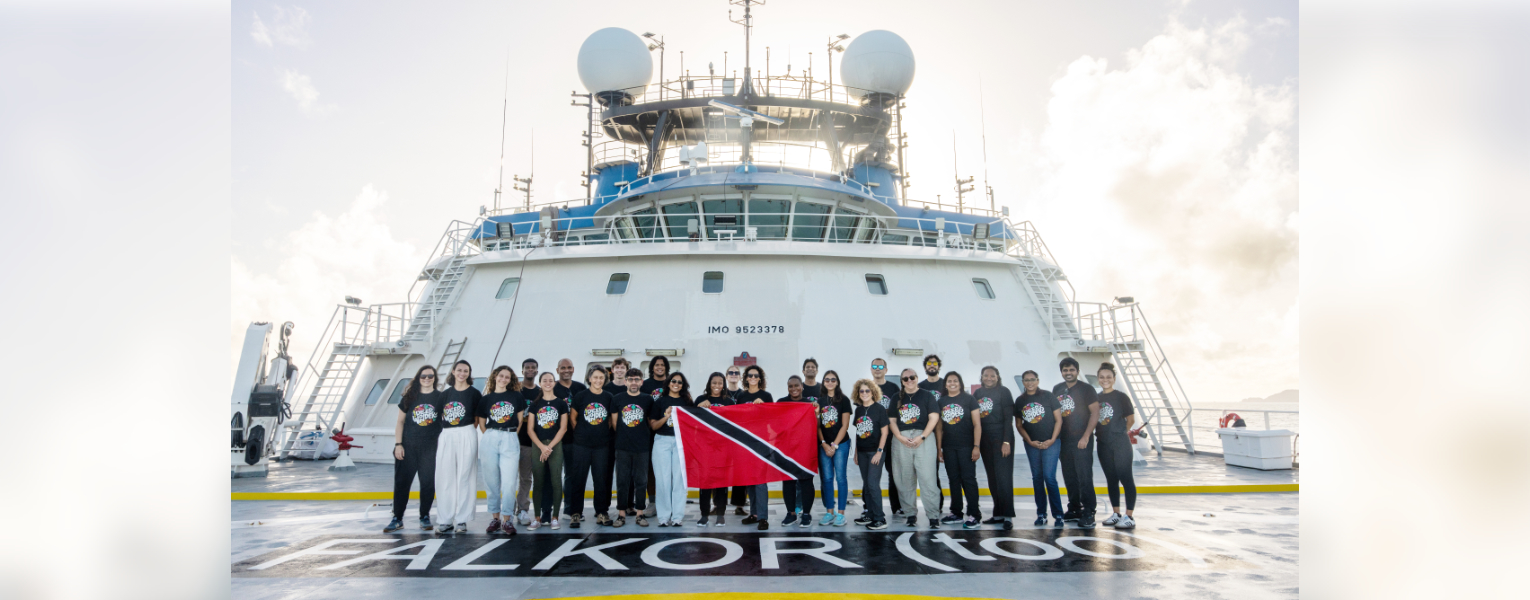 Group of researchers standing in front of Falkor (too)' ship. Photo credit: Mónika Naranjo González / Schmidt Ocean Institute