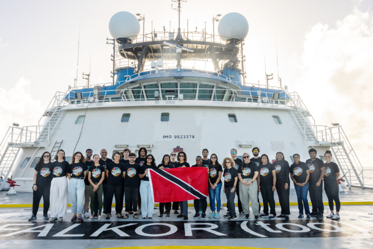 Group of researchers standing in front of Falkor (too)' ship. Photo credit: Mónika Naranjo González / Schmidt Ocean Institute