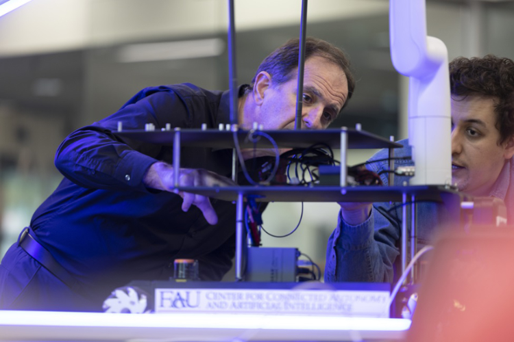 Dimitris Pados, Ph.D., (left) principal investigator and director of FAU's Center for Connected Autonomy and Artificial Intelligence. (Photo by Alex Dolce)
