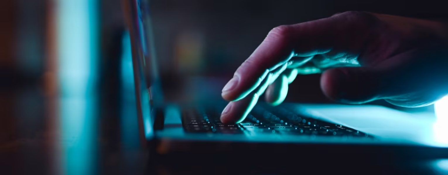image of hands typing on laptop keyboard