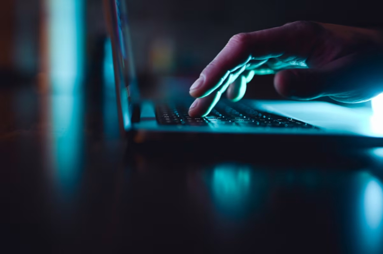 hand typing on laptop keyboard
