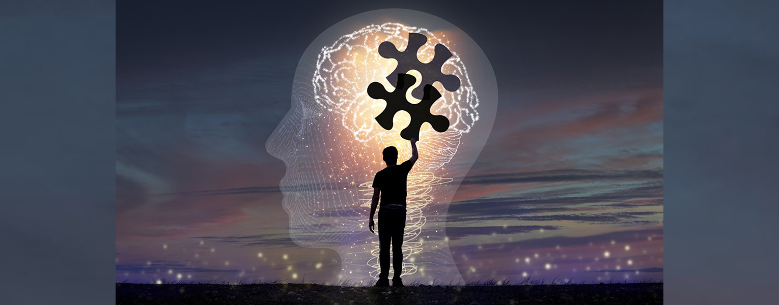 purple and gray background with glowing brain and puzzle piece and silhouette of person reaching upward