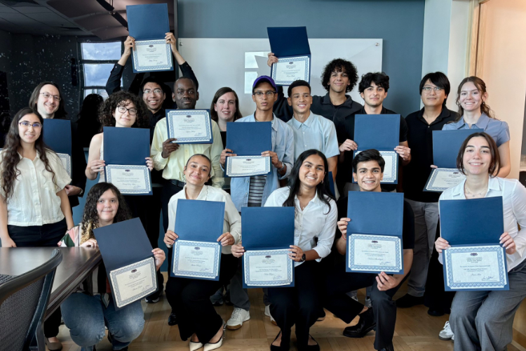 group of students in classroom setting, holding certificates