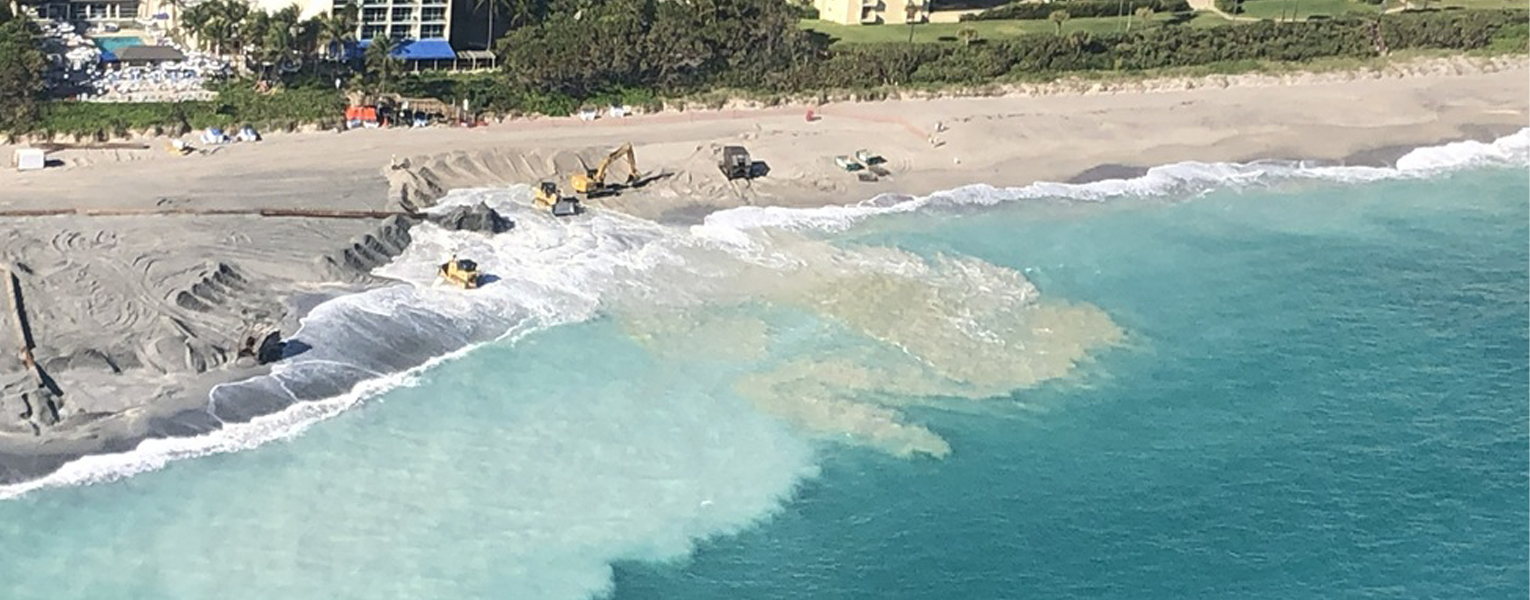 ocean and beach with building in background