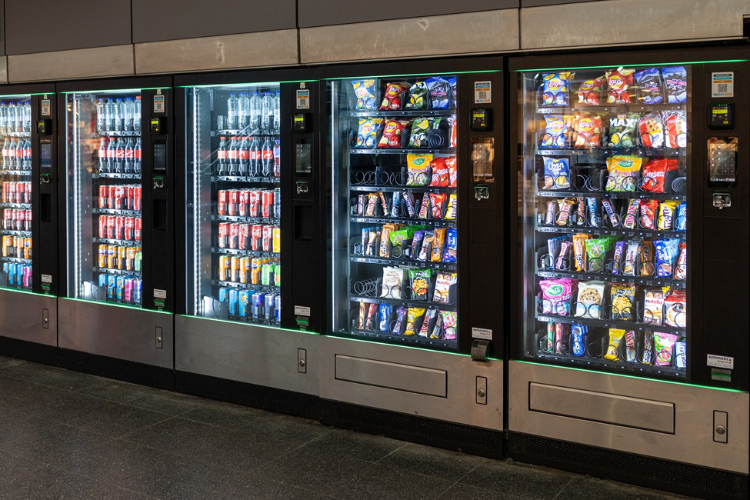 row of vending machines with ultra-processed food options