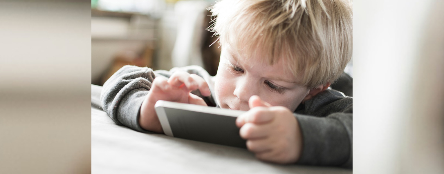 child looking at mobile device