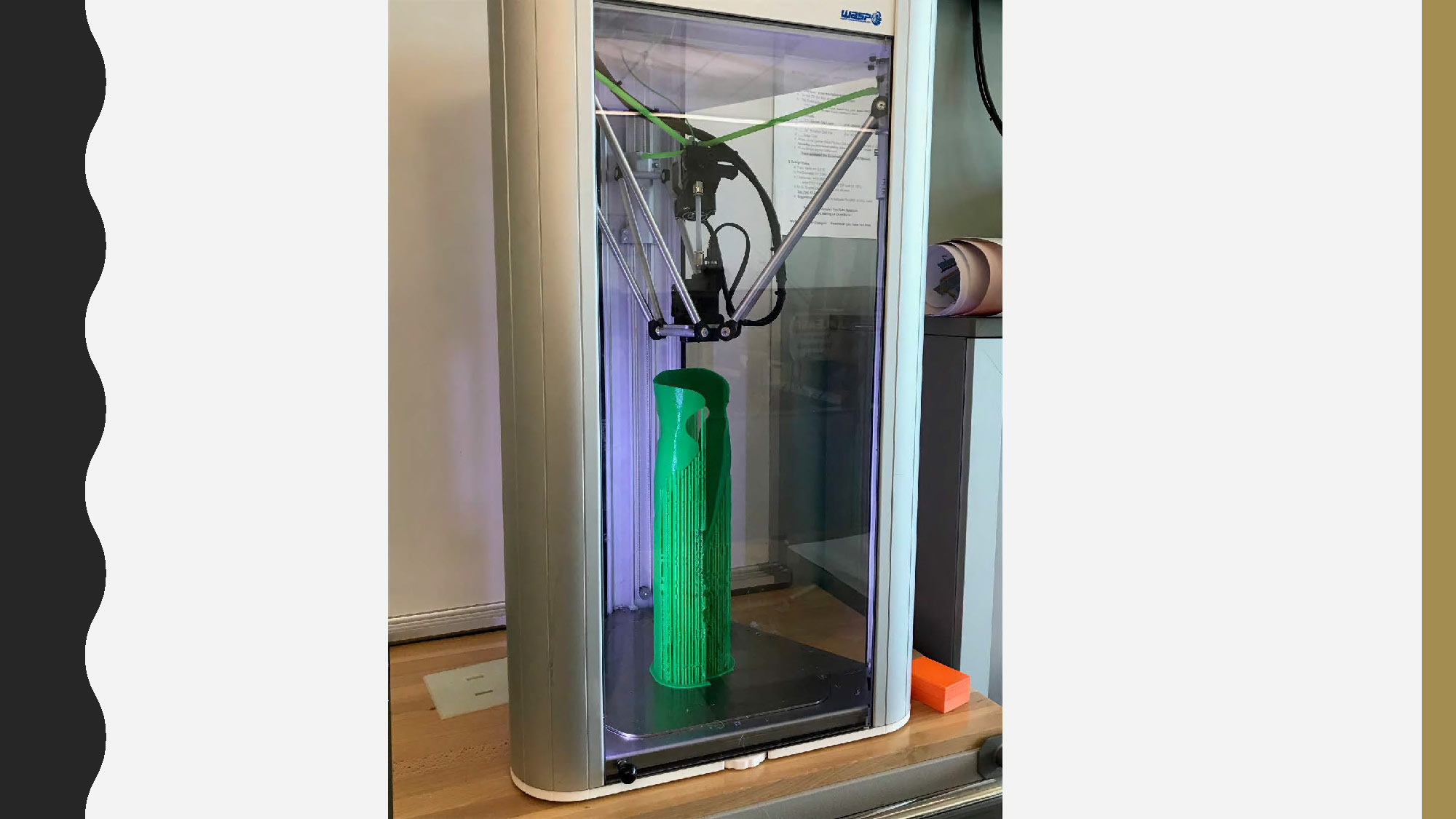 Slide 11: close-up shot of a 3D printer