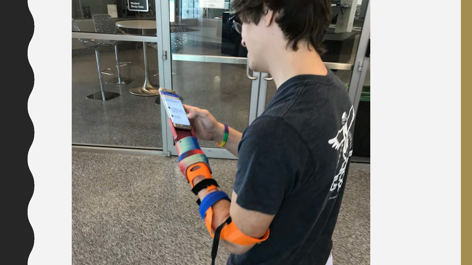 Slide 13: side view of a person standing indoors, looking down at their cell phone
