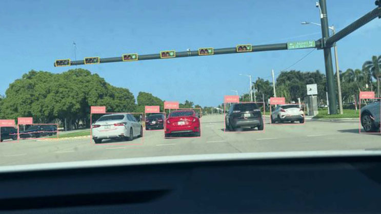 Slide 22: A full-slide dashcam photograph taken from inside a car at an intersection, with vehicles and traffic signal heads annotated with bounding boxes from an object-detection model.