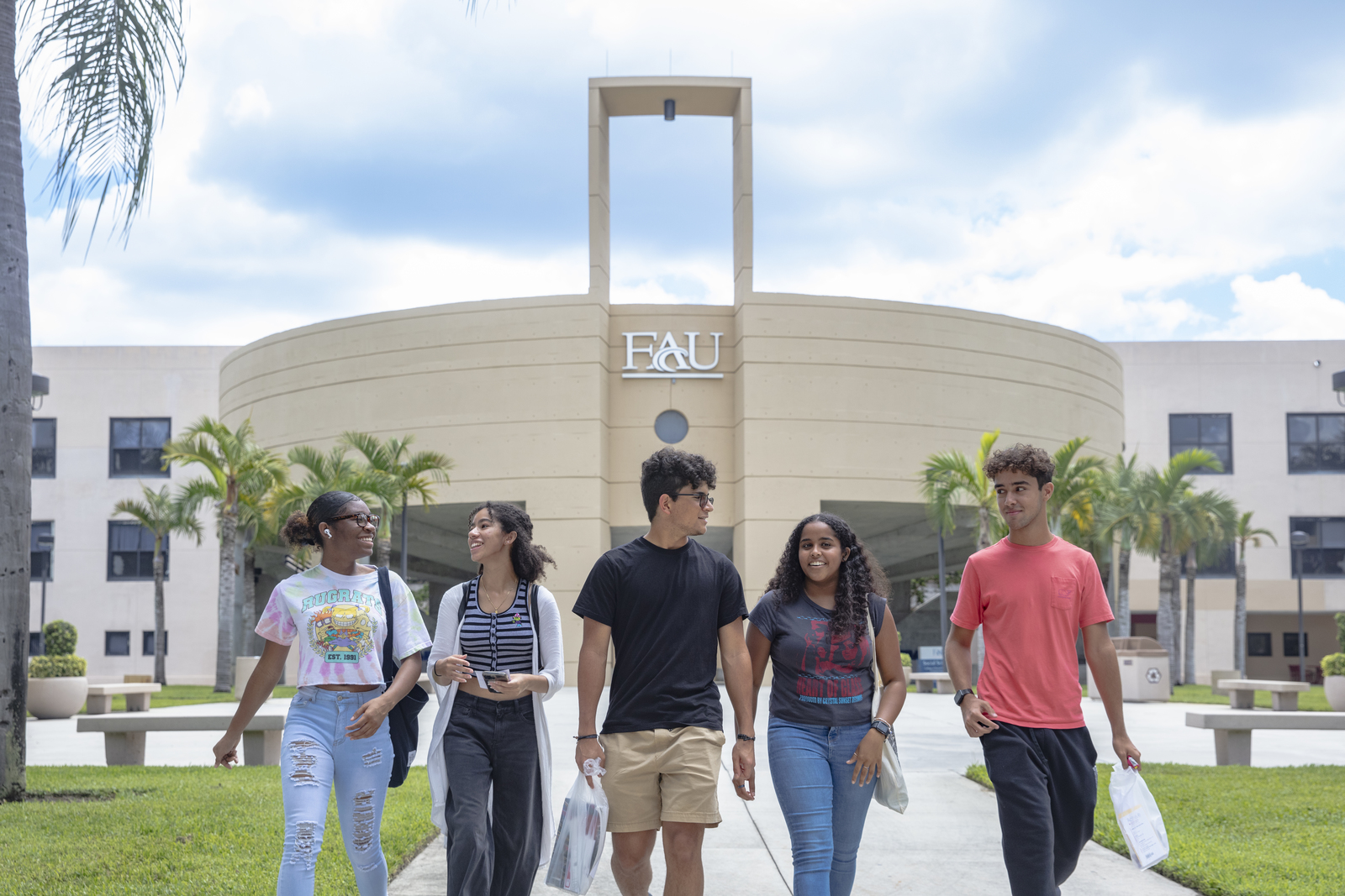 Professor and student walking in front of the Social Sciences building at FAU