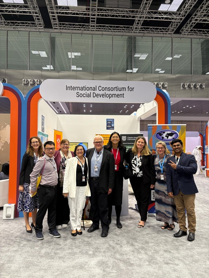 Group phoro in front of International Consortium for Social Development sign