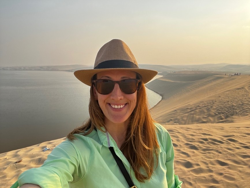 Colvin taking a selfie with dunes in the background