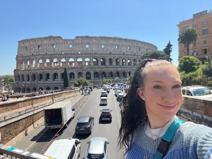 Snapping a selfie outside of the Roman Coliseum during a solo trip to Italy