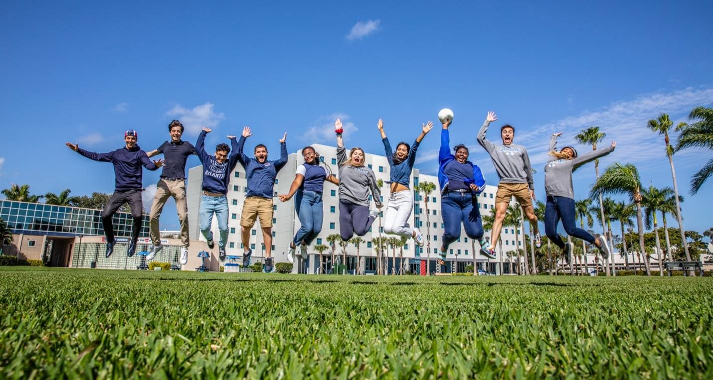 FAU students jumping in the air