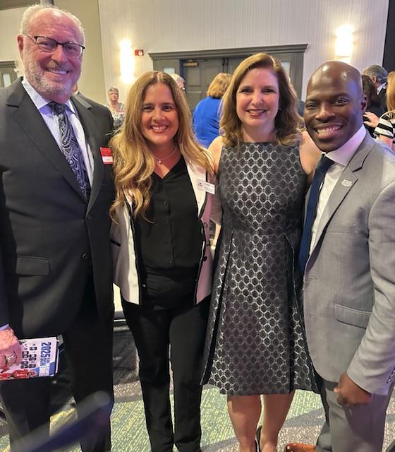 Four people smiling for a photo