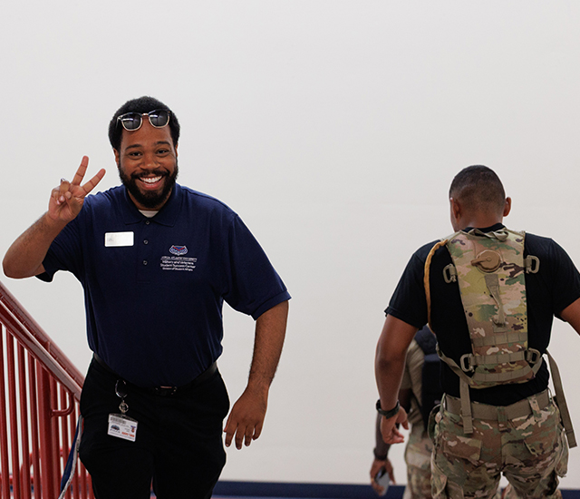 Staircase challenge participants walking up the steps showing victory sign