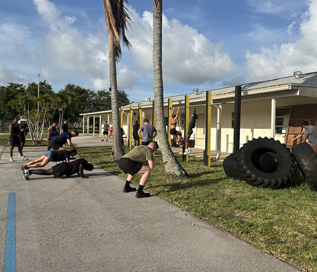 Students doing pullups, push ups and squats