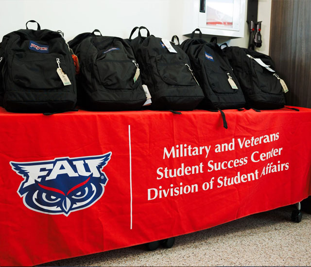 backpacks on a table with a red FAU cover