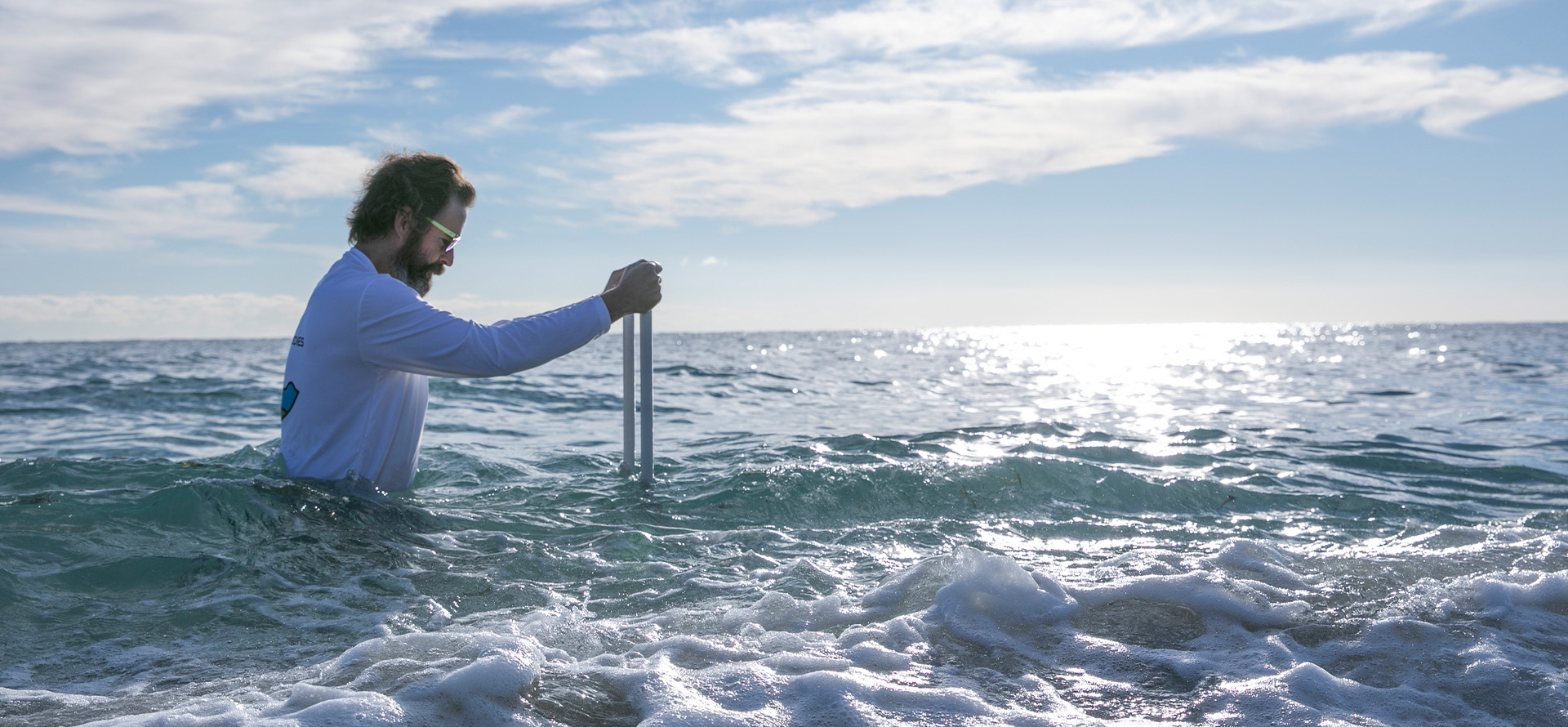 researcher conducting experiment in the shallow area of the ocean